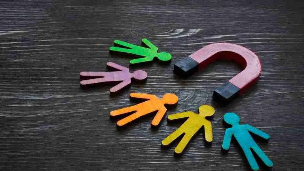 Magnetic shapes shaped like people, plus horseshoe-style magnet attracting the people shapes 