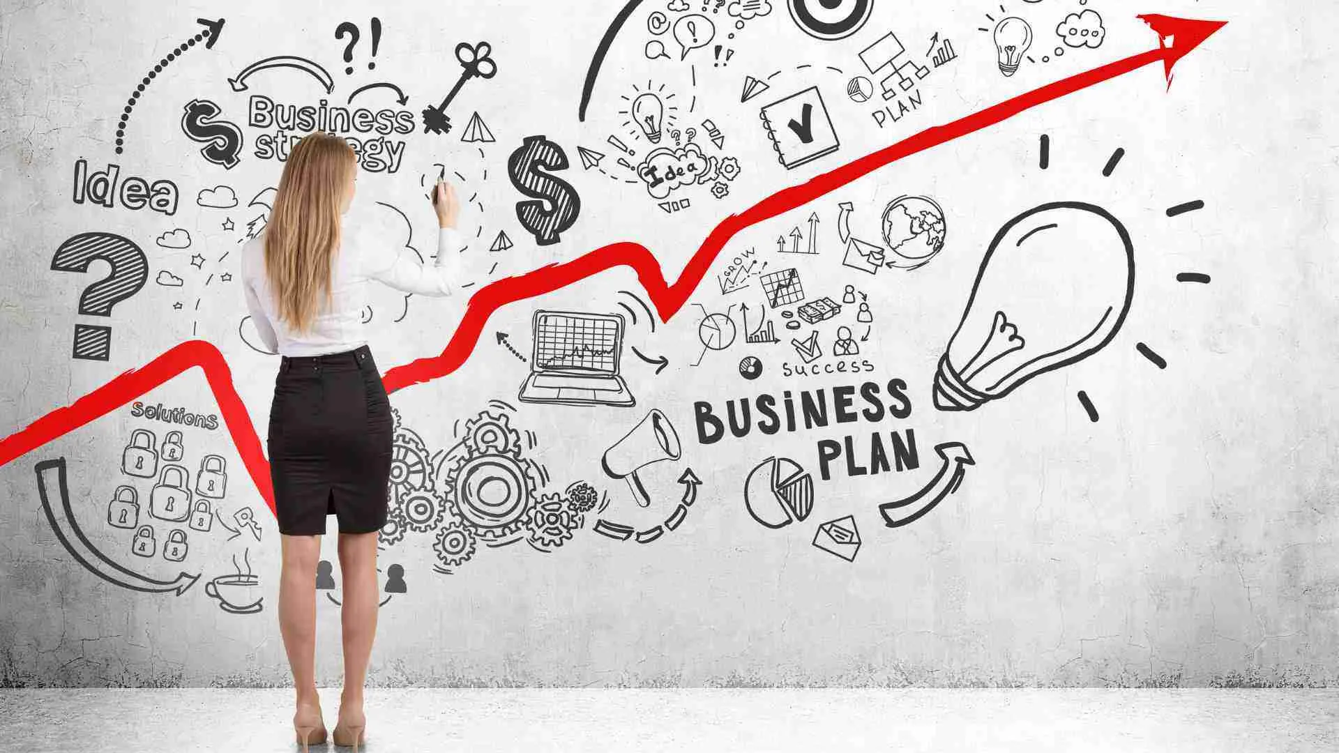 Woman writing her business plan with a sharpie on a whiteboard, having drawn a huge, upwards big red arrow to show business growth